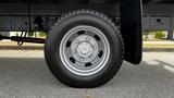 Close-up of a silver wheel with a tire mounted on a 2018 Mitsubishi Fuso FE truck