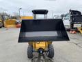 A 2024 AGT Industrial KRW23 Mini Loader with a large front bucket and rubber tires facing forward