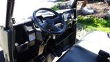 Interior view of a 2016 Polaris Ranger 570 Crew showcasing the steering wheel dashboard and driver's seat