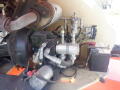 A close-up view of the hydraulic system and engine components of a 2008 JLG Boom Lift showcasing various pipes and connectors