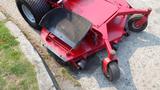 A red 2014 Ferris Mower ISX 800 with a large cutting deck and wheels designed for grass trimming and lawn maintenance