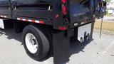 A 2012 International DuraStar 4300 truck with a black body and visible rear tires and tailgate features