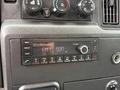 Dashboard control panel of a 2022 International MV607 featuring radio display knobs and buttons for media and volume adjustment