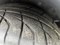 Close-up of a worn tire from a 1992 Chevrolet Corvette showing distinct tread patterns and dirt accumulation on the rubber surface