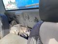 Interior view of a 2009 Dodge Ram 5500 showing the back seat area with fabric upholstery and cluttered items on the floor