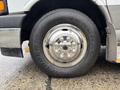 A close-up of a wheel on a 2020 Chevrolet Express featuring a polished chrome hubcap and a heavy-duty tire with the brand name General visible on the sidewall
