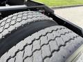 Close-up of two tires on a 2012 Volvo VNL showcasing a well-worn tread pattern and robust structure