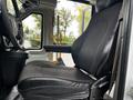 A 2019 Chevrolet Express driver's seat featuring fabric and leather materials with armrest and seatbelt visible