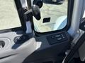 Close-up of the driver side interior controls of a 2018 International DuraStar including window and mirror adjustment buttons