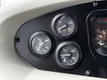 Dashboard of a 2015 Spartan School Bus featuring three circular gauges displaying pressure temperature and oil levels