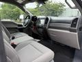 Interior view of a 2022 Ford F600 showing a spacious cabin with two front seats and a dashboard featuring a touchscreen display and controls