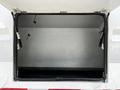 A partially open storage compartment of a 2012 Freightliner M2 106 with a smooth interior surface and reinforced edges