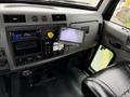 Interior dashboard of a 2016 Peterbilt 348 showing controls a screen and a cup holder