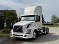A 2012 Volvo VNL truck with a white exterior and large cab is parked, featuring a prominent front grille and a streamlined design