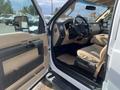 Interior of a 2014 Ford F-350 SD showing beige upholstery dashboard steering wheel and door panel