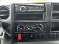 Dashboard of a 2013 Hino 195 featuring a radio and various climate control knobs and buttons