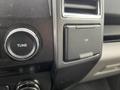 Close-up of the dashboard controls in a 2016 Ford F-150 featuring a tune knob and a 12V power outlet