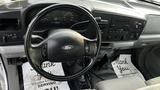 Interior view of a 2007 Ford F-550 featuring a steering wheel dashboard and audio controls with floor mats displaying a thank you message