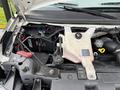 A 2020 Chevrolet Express van with the hood open showing the engine compartment and various components including hoses and fluid reservoirs
