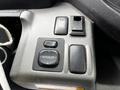 A close-up of the control panel in a 2014 Hino 195 featuring buttons for mirror adjustments and fog lights
