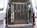 A 2009 Dodge Sprinter Van with a Braun Millennium series wheelchair lift extended in the rear cargo area