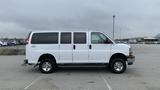 A 2017 Chevrolet Express Quigley 4x4 van with a white exterior and chrome wheels parked on a lot