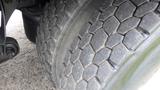 Close-up view of a worn tire on a 2012 International 7400 featuring deep tread patterns and visible cracking on the rubber surface