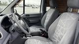 Interior of a 2012 Ford Transit showing two front seats with gray patterned upholstery and a steering wheel