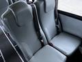 Two gray seats with seat belts in a vehicle interior