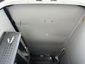Interior view of a 2017 Mercedes-Benz Sprinter cargo van with metal shelving installed and a clean, enclosed ceiling