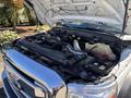 A 2016 Ford F-550 with its hood open showcasing the engine compartment and various components including hoses and a coolant reservoir