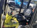 Interior of a 2010 Kubota F3680 tractor showing the steering wheel seat and control levers in a cab setup