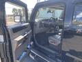 Interior view of a 2003 Hummer H2 showing the driver's seat steering wheel and dashboard with controls