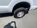 A 2016 Ford F-350 SD with a chrome wheel and a large tire visible in the foreground