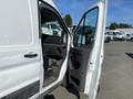 A 2022 Ford Transit van with the driver's side door open, revealing the interior dashboard and seating area