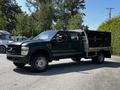 A 2008 Ford F-550 truck with an extended cab and a utility bed equipped with compartments for storage