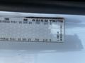 A 2004 Freightliner M2 tire information label displaying tire size cold PSI ratings and part number