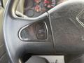 Close-up of the steering wheel of a 2013 International Durastar 4300 featuring a cruise control switch with labels for on and off options