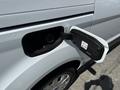 Close-up of the fuel filler door of a 2021 Ford Transit Connect showing the opened cap and nozzle slot