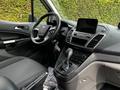 Interior view of a 2019 Ford Transit Connect showing the driver's seat steering wheel and dashboard with a touchscreen display and gear shift