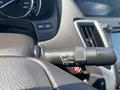 A close-up of the windshield wiper control stalk in a 2017 Acura TLX featuring various settings like mist off pull and auto