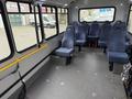 Interior of a 2017 Chevrolet Express van featuring blue upholstered seating and a spacious open area with a low floor design