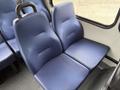 A pair of blue upholstered seats in a van with a textured fabric finish