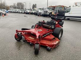 A red 2017 Ferris Rotary lawn mower with a large cutting deck and a rider seat is parked on a gravel surface