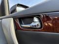 Interior door handle of a 2017 Infiniti QX50 featuring a chrome finish and wood trim
