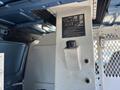 A white metal compartment with a control panel and a dark cap located inside the rear of a 2008 Ford E-350 van