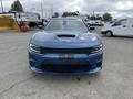 A blue 2022 Dodge Charger with a sleek front design and hood vent showcasing its sporty appearance