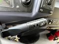 A close-up of a control lever with on and off settings labeled for cruise control in a vehicle interior
