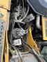 Close-up of the machinery and hydraulic components of a 2018 John Deere 350 including pipes and valves