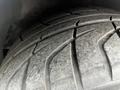 Close-up of a worn tire with visible tread patterns and dust on the surface of a 1992 Chevrolet Corvette
